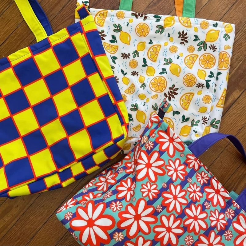 Collection of colorful cotton tote bags with lemon, floral, and checkerboard patterns, textile art licensing portfolio by Mirador Art Studio