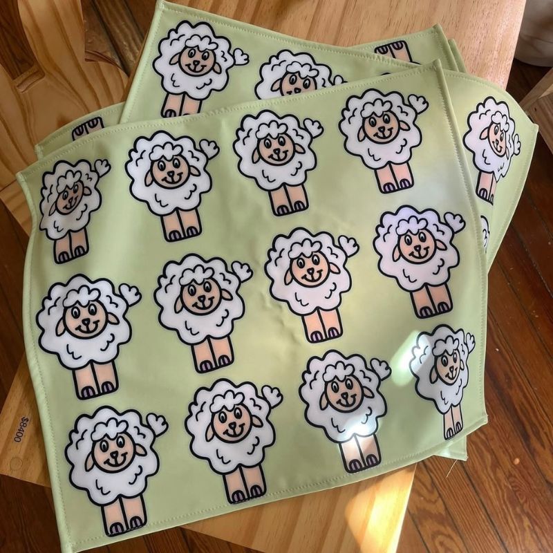 Cute sheep pattern placemats for kids, whimsical character illustration for home textiles by Mirador Art Studio.