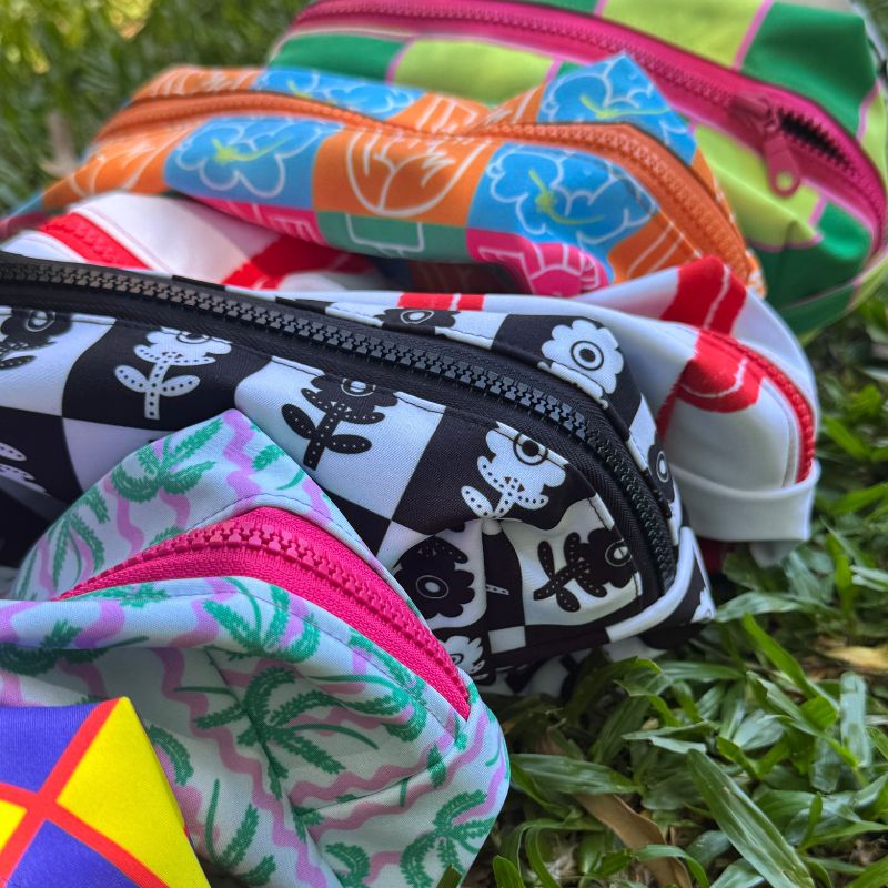 Artistic zipper pouches featuring colorful whimsical patterns, art licensing product examples by Mirador Art Studio.